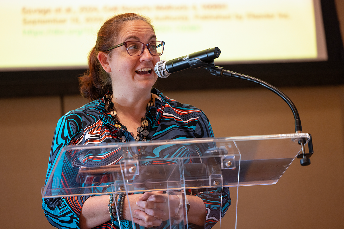 Cagla Eroglu, PhD speaking from a podium